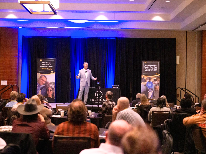 Scott speaking on stage at the Summit